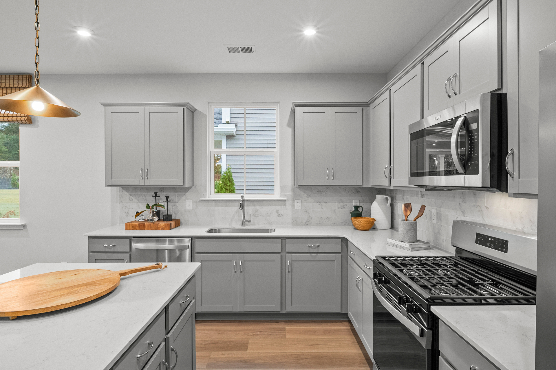 Designer kitchen with quartz countertops and gold fixtures
